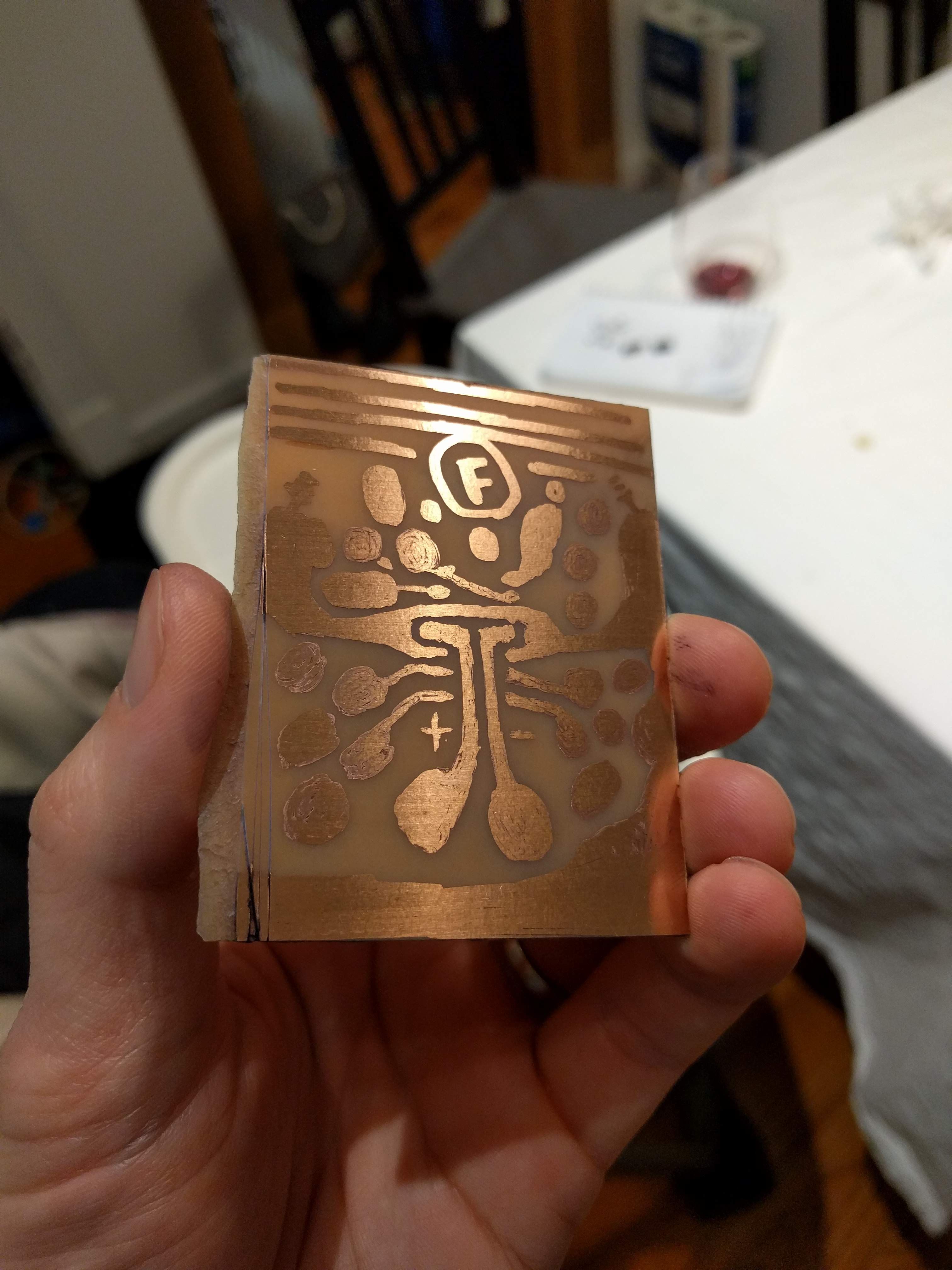 Photo of the copper clad board in the previous photo after etching. The parts that were drawn in sharpie are now copper traces, the rest is bare non-conductive board.