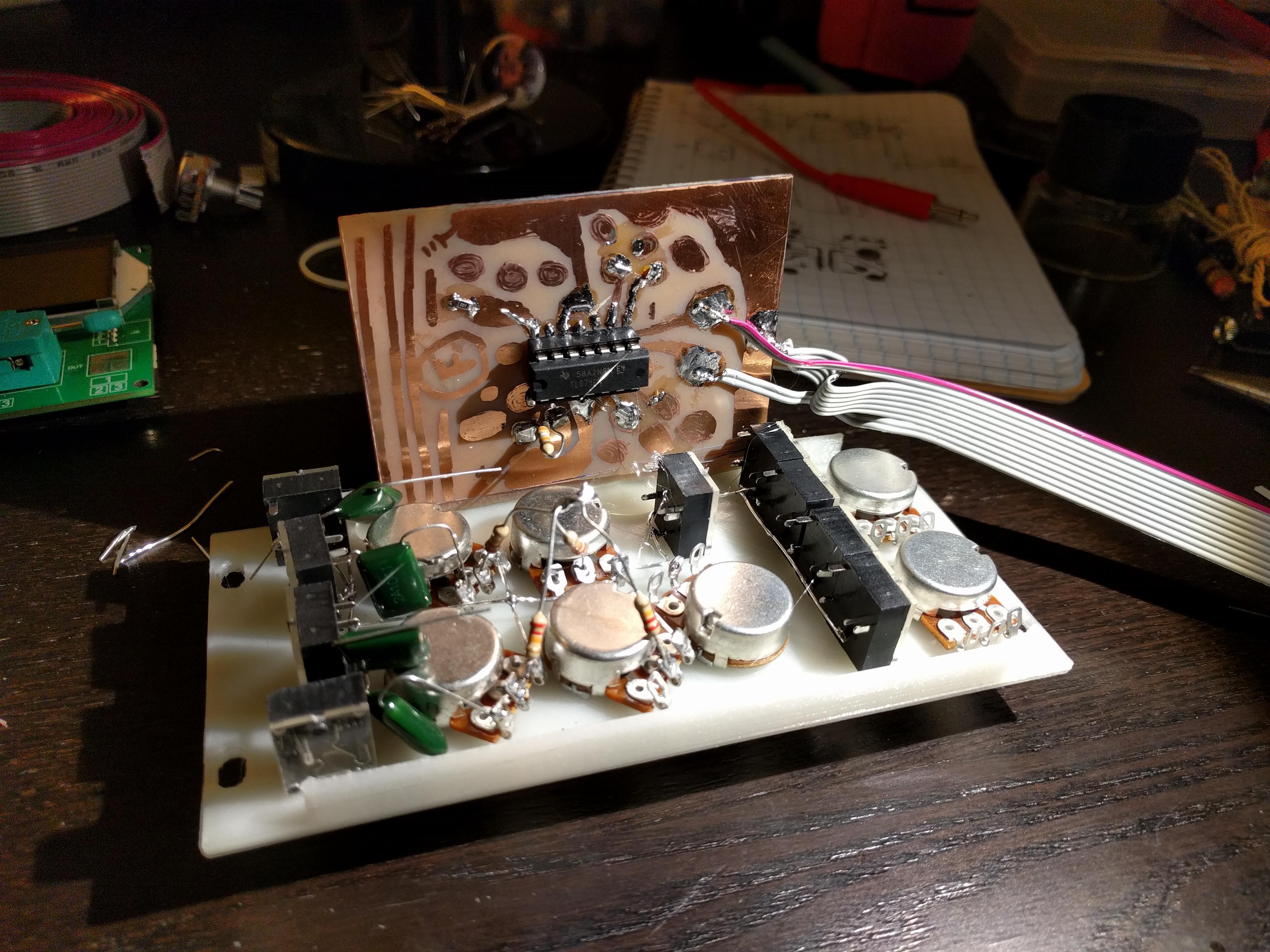 Photograph of a hand-drawn circuit diagram for a 4-channel mixer and a sketch of that circuit on a small piece of copper-clad board in sharpie.